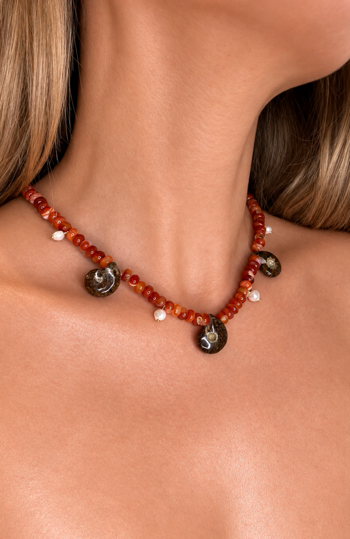 Agate neckace with three Ammonite fossil pendants and four small pearl drop pendants.