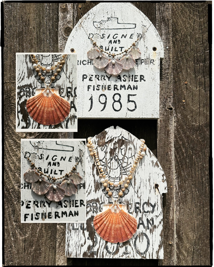 Two difference necklace styles hanging on nautical fishing signs.